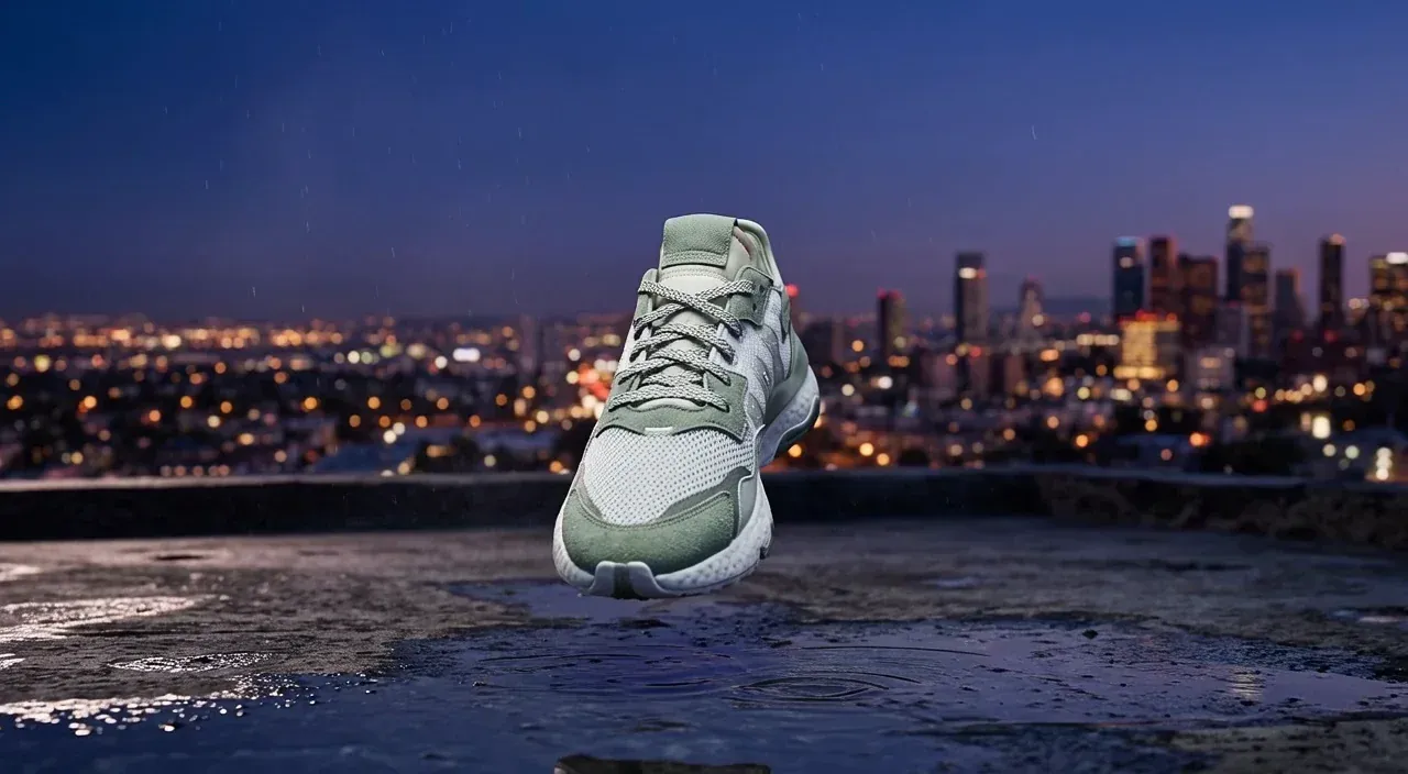 Frame from a Grok Imagine Video 1.5 sneaker ad clip with city lights behind